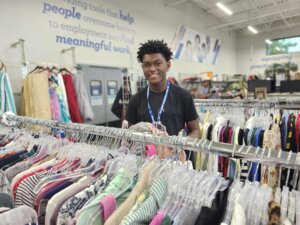 Transitioning Youth participant works at the Winter Garden Goodwill store